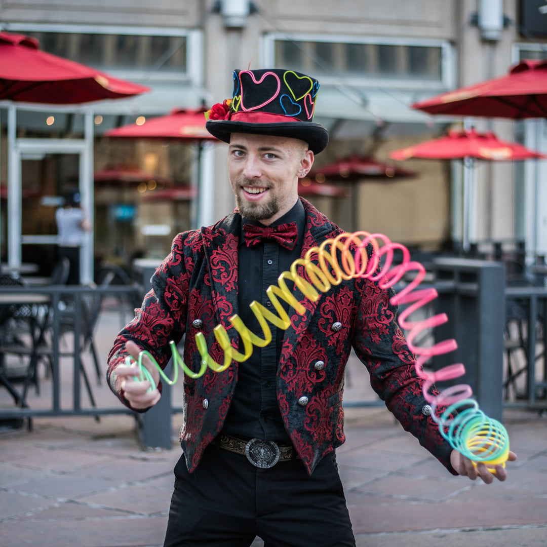 Slinky Josh in a colorful, quirky outfit, street performing on the 16th Street Mall in Denver, Colorado. 