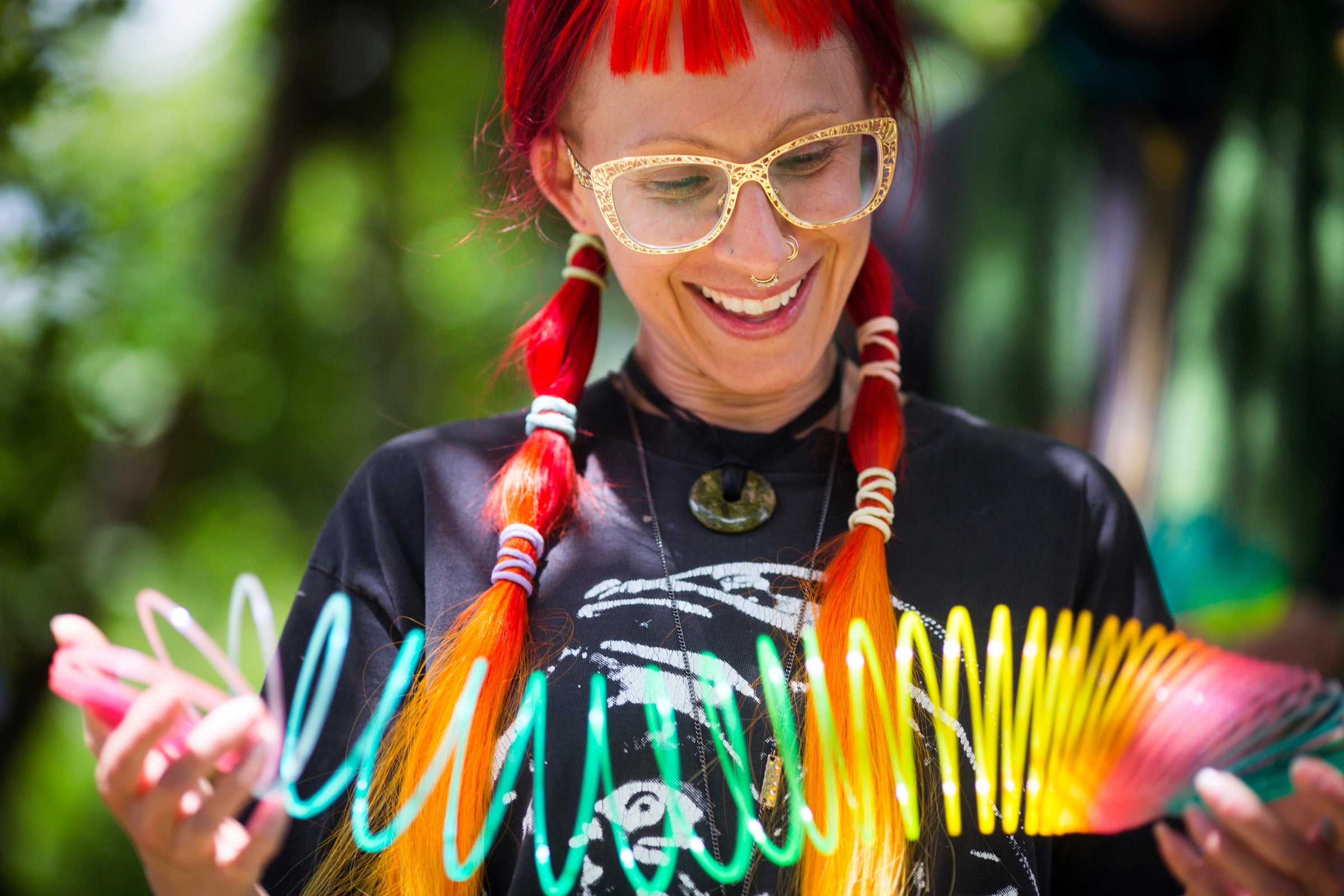 A beautiful young woman with vibrant red hair smiles at her HyperSpring as she tries it for the first time.
